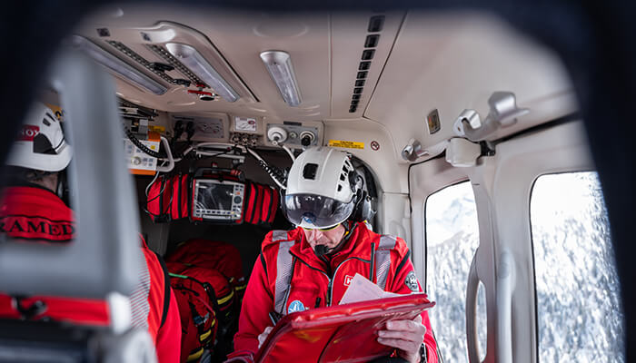 man going through plans on a helicopter